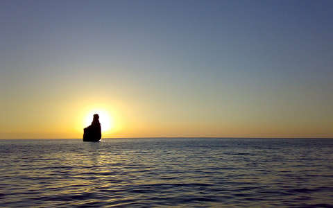 kövek és sziklák naplemente tenger